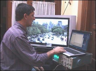 Testing the Transport Stream with a PC, while viewing the HD signal with an LCD HDTV; below the LCD is the STB (black box) and over the STB is the little 1-seg screen for mobile/portable. The signal on the oscilloscope is the HD output from the STB.